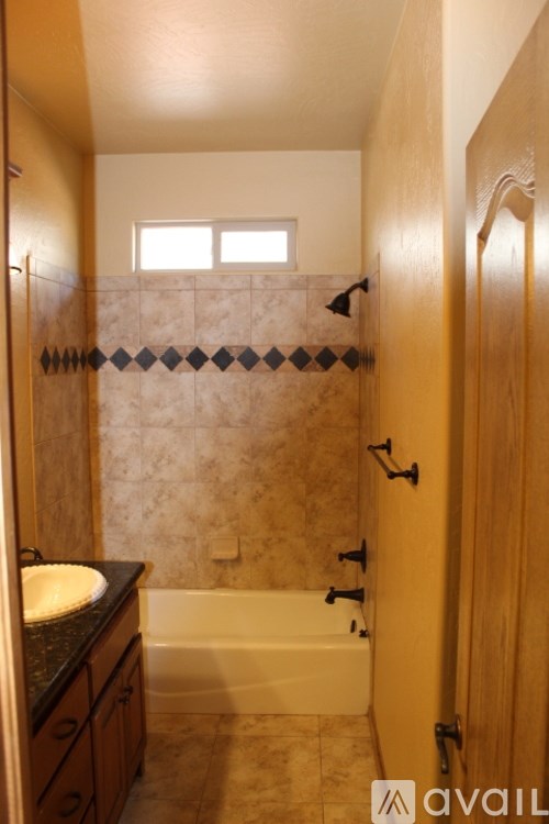 A bathroom with a tub, sink and wooden doors.