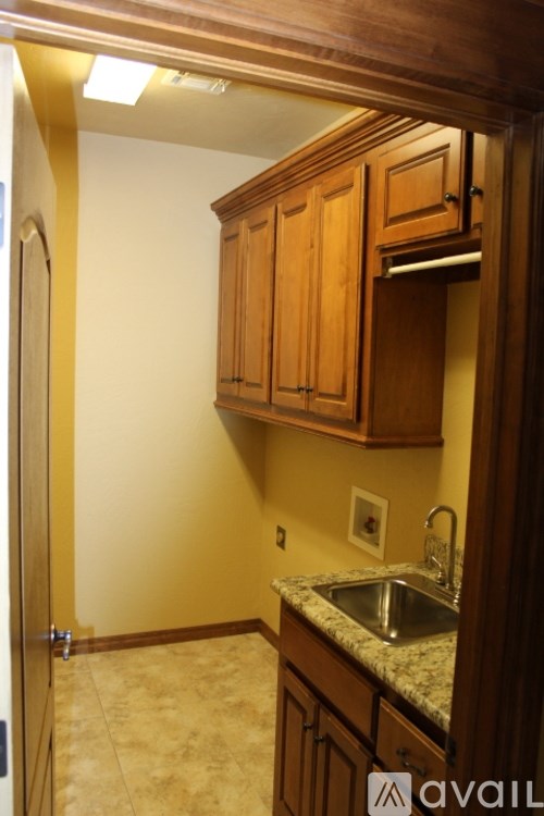 A kitchen with wooden cabinets and a granite countertop.