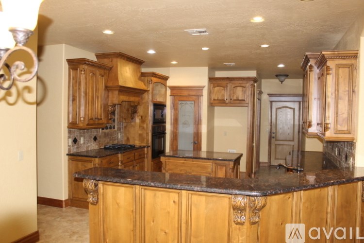 A kitchen with wooden cabinets and granite countertops.