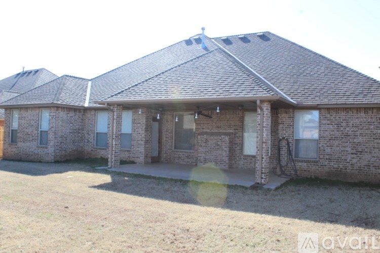 A brick house with a brown roof and a white door.