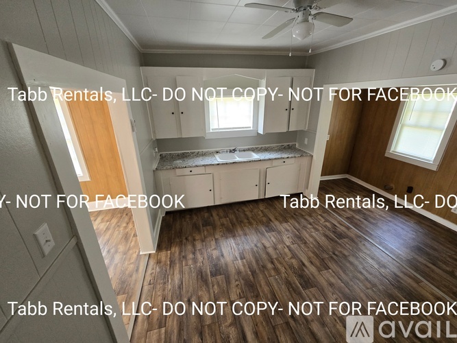 A room with wooden floors and a ceiling fan is shown with a disclaimer from Tabb Rentals, LLC.