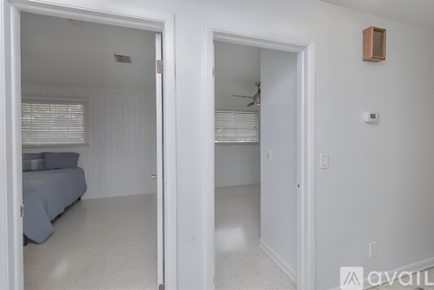 A bedroom with a bed and a ceiling fan.