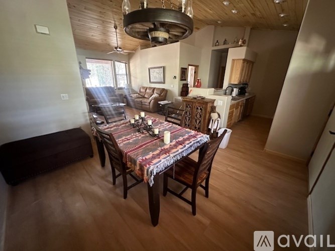 A dining room with a table set for a meal.