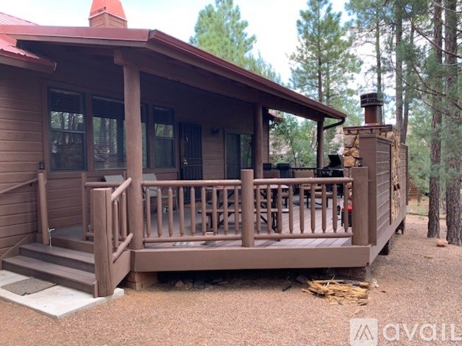 A small cabin with a porch and a wood stove.