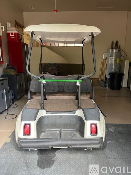 A vehicle with a white canopy and a brown seat is parked indoors.