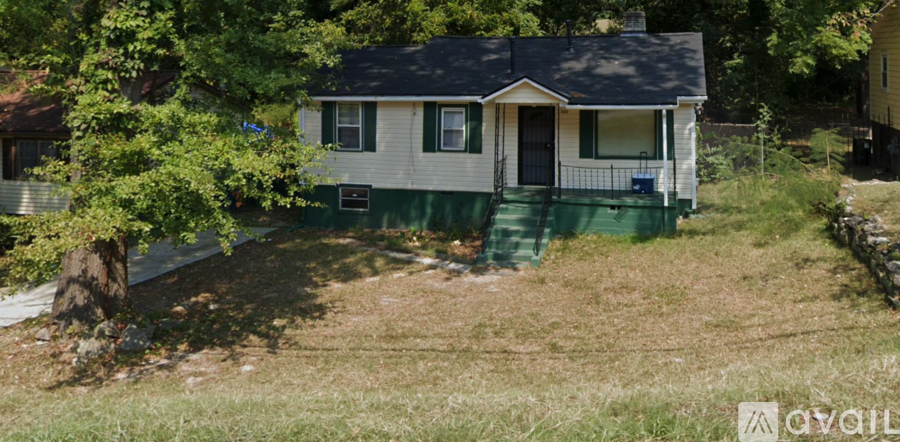 A small house with a green front porch.