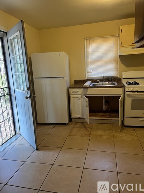 A kitchen with a white fridge, white stove, and white oven.