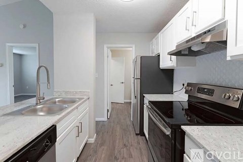 A kitchen with a black refrigerator and stove.