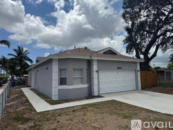 A house with the number 890 on it is for sale.