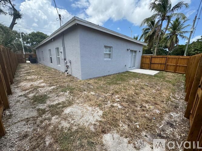A small house with a fence and a yard.