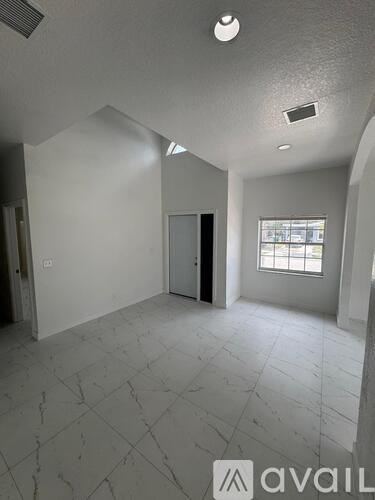 A room with a tiled floor and a window letting in natural light.