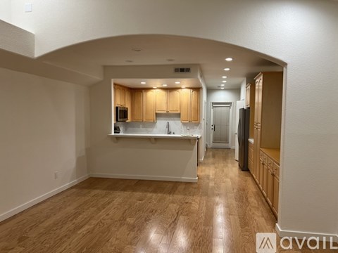 A kitchen with wooden floors and cabinets is available for rent.