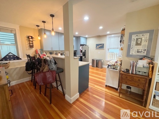 A kitchen with a dining table and chairs.