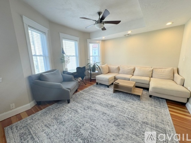 A bedroom with a large bed and a ceiling fan.