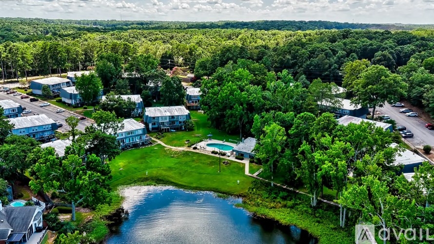 A bird's eye view of a resort with a swimming pool and surrounding greenery.