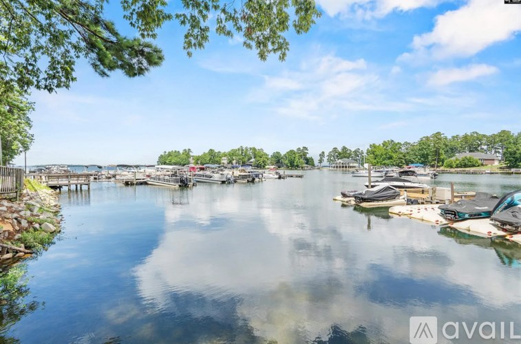 A serene waterfront scene with boats docked and a clear sky.