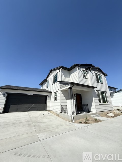 A two-story house with a garage is available for sale.