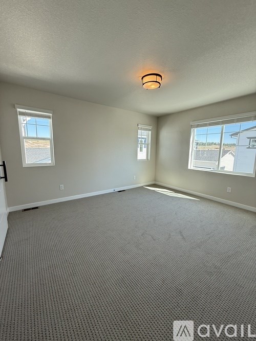 A long hallway with a carpeted floor and white walls.