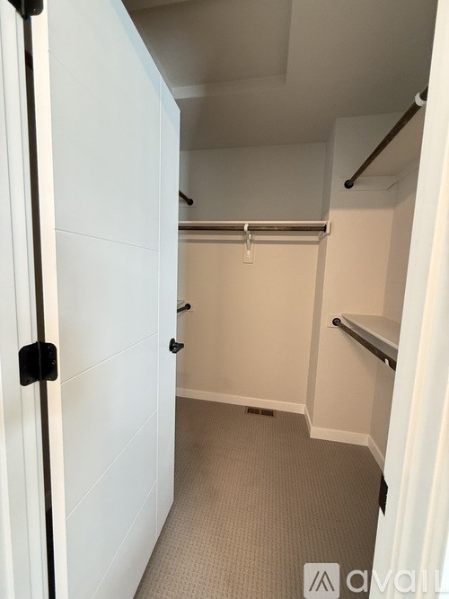 A room with a carpeted floor and a window.