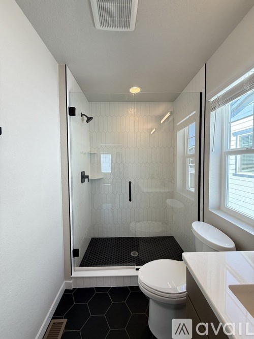 A room with a window and carpeted floor.