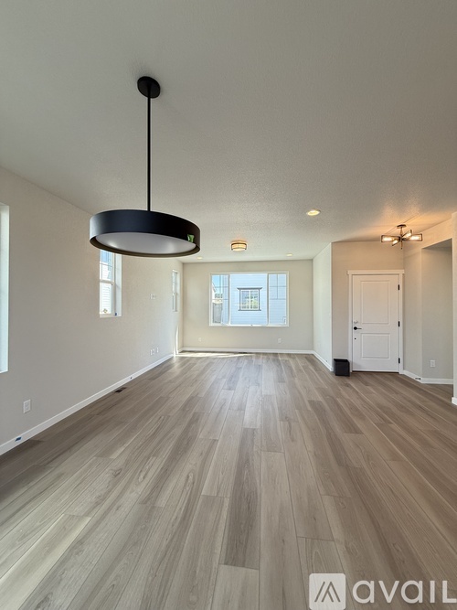A kitchen with black cabinets and a countertop with a white paper towel on it.