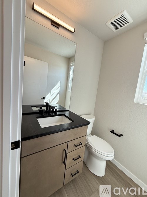 A kitchen with black cabinets and a countertop with a white towel on it.
