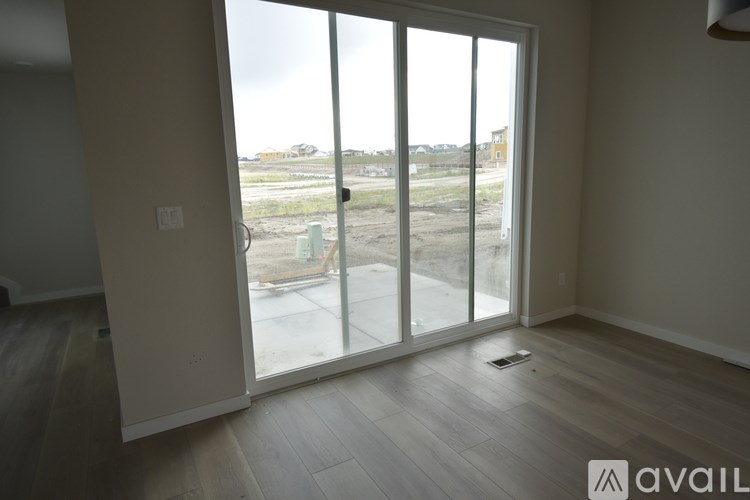A room with a view of a construction site through a large window.