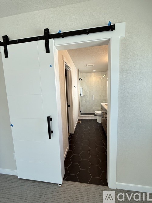 A bathroom with a toilet, sink, and mirror is under construction.