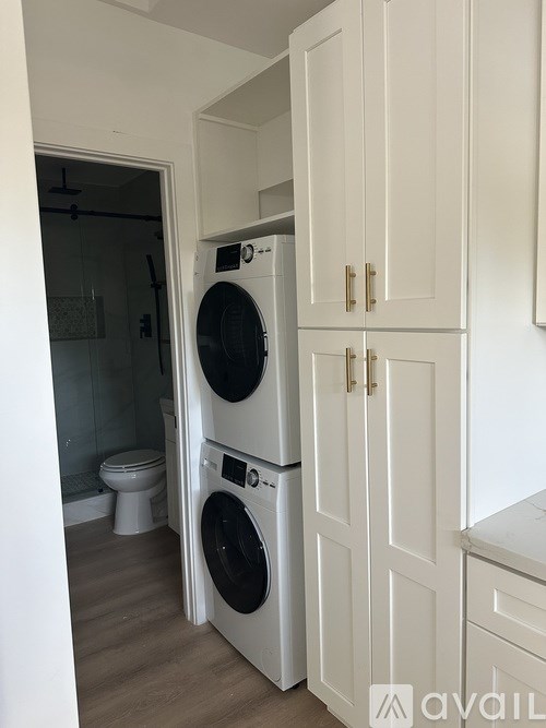 A white laundry room with a washer and dryer.
