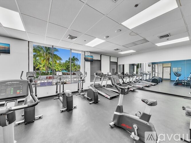 A gym with treadmills and exercise bikes.