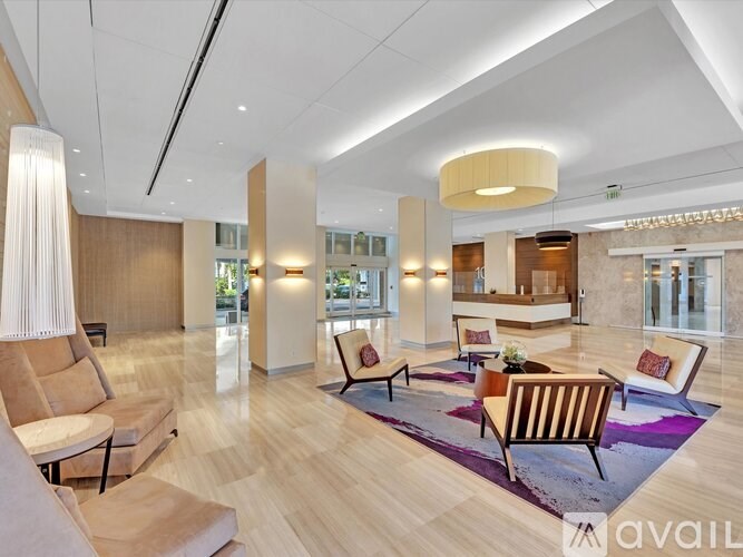 A spacious living room with a variety of seating options and a large window.