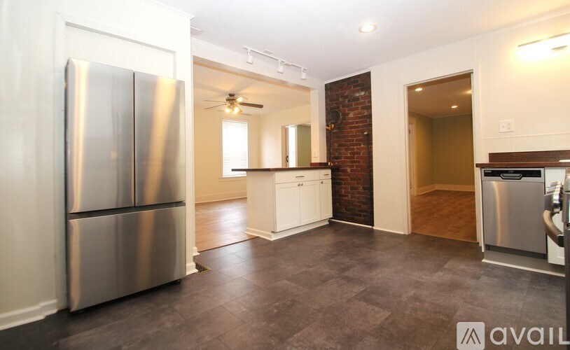 A kitchen with a refrigerator, a dishwasher, and a microwave.