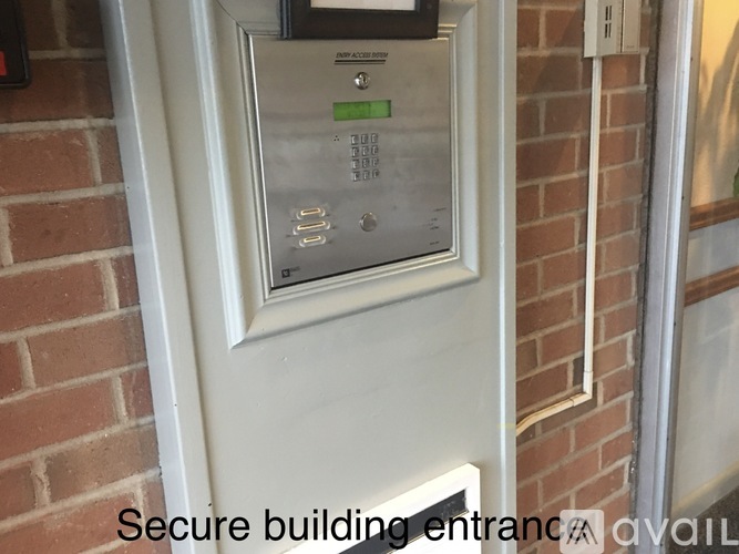 A secure building entrance with a keypad and a digital display.