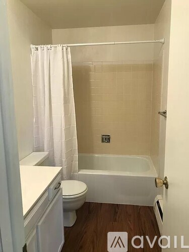 A small white bathroom with a toilet, sink, and bathtub.