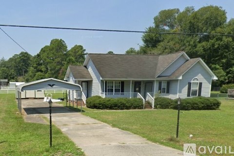 A house with a grey roof and a covered patio.