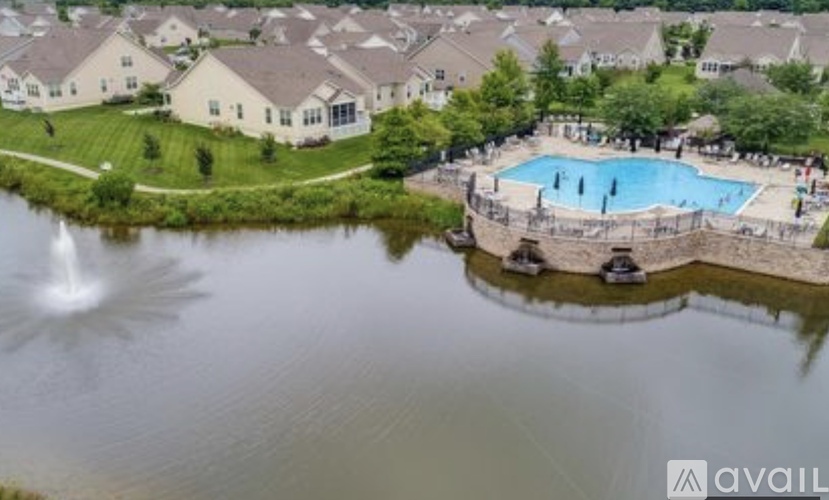 A swimming pool surrounded by houses and trees.