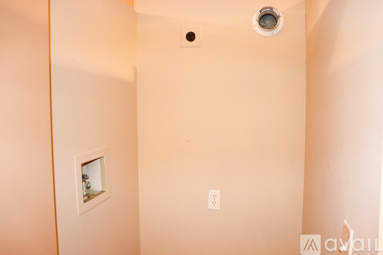 A bathroom with a toilet and a picture on the wall.