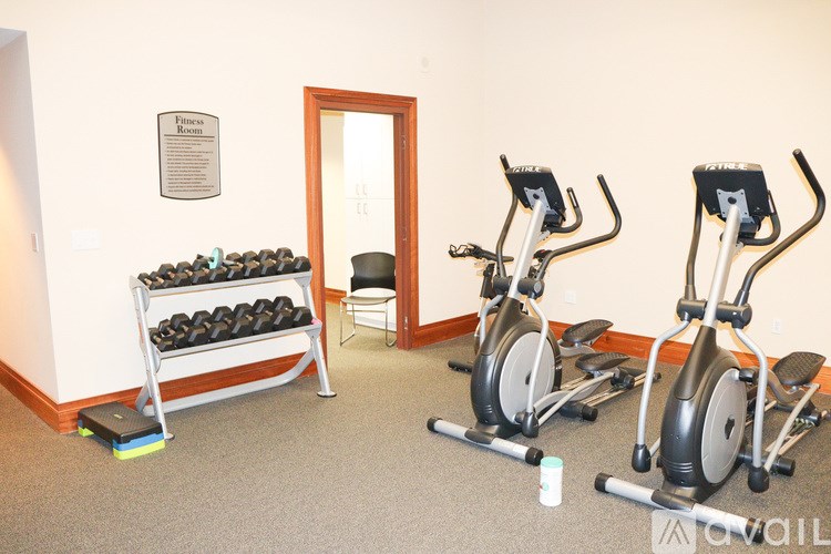 A room with exercise equipment and a sign on the wall.