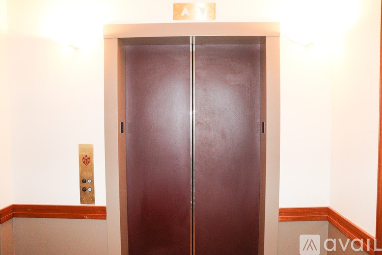 A brown door with a sign above it.
