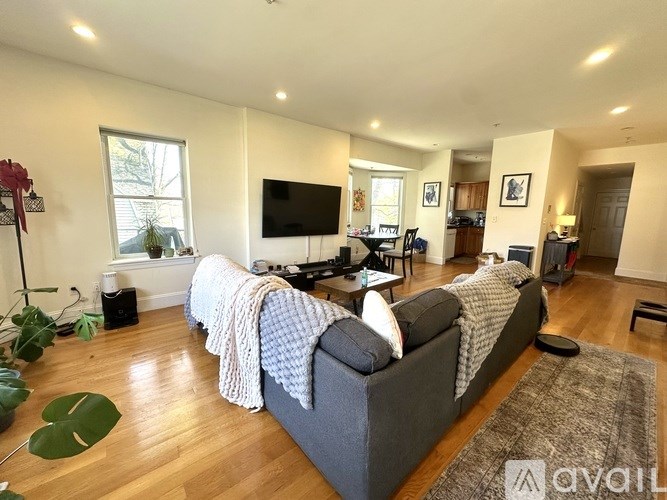 A living room with a grey couch and a television.