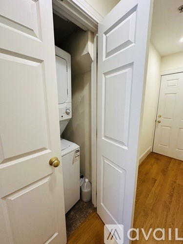 A bathroom with a white sink, toilet, and a shower with a curtain.