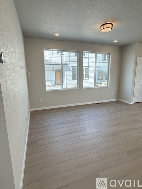 A kitchen with a window and tile flooring.