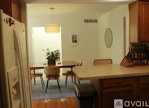 A kitchen with a table and chairs in the middle of the room.
