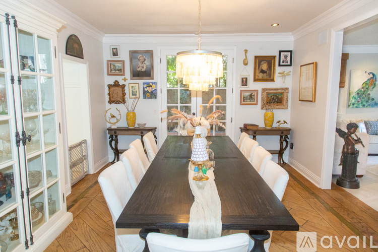 A dining room with a long table and chairs.