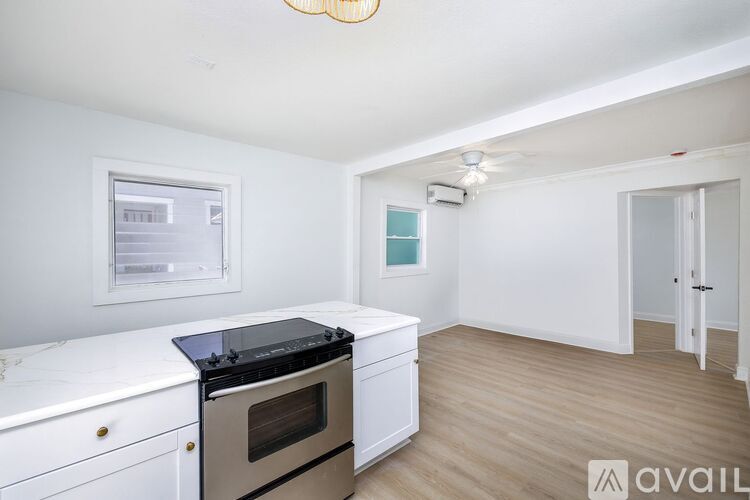 A kitchen with a stove top oven and a fridge.