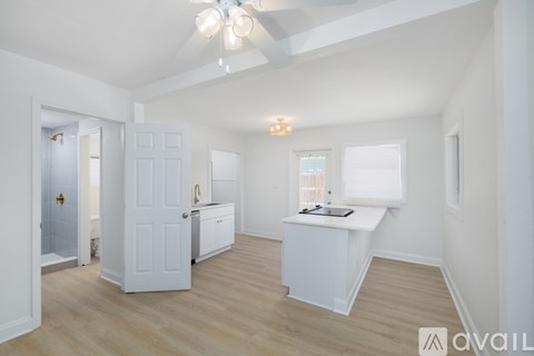 A spacious room with a white cabinet and a window.