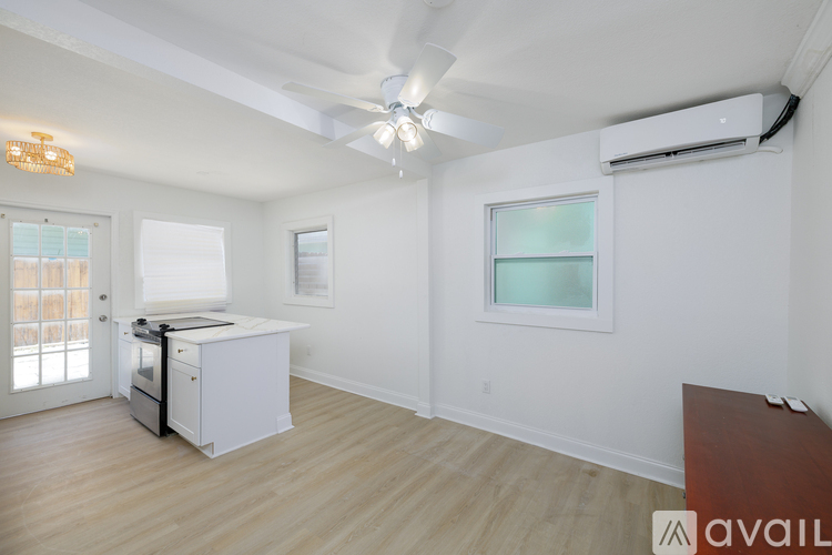 A room with a white wall and a window with a white frame.