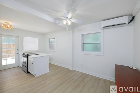 A room with a white wall and a window with a white frame.