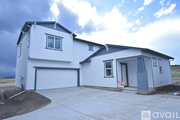 A house with a garage is for sale.