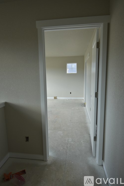 A room with a doorway leading to another room.